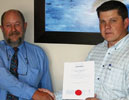 Pierre Enslin, BM Trada (left) hands the coveted ISO certificate to Albert Bower, managing director of Becker Electronics, part of the Becker Group of Companies